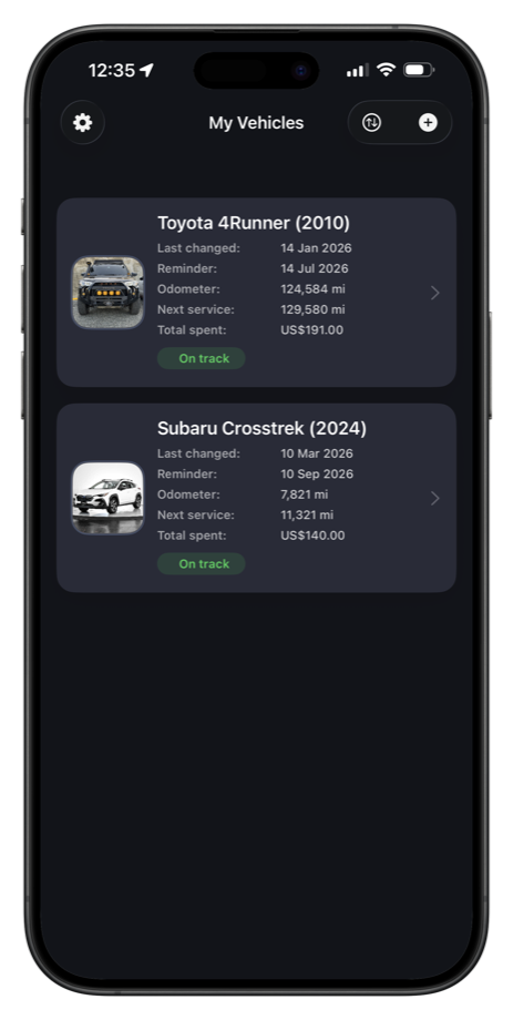 CarMGT dark mode garage screen with vehicle cards